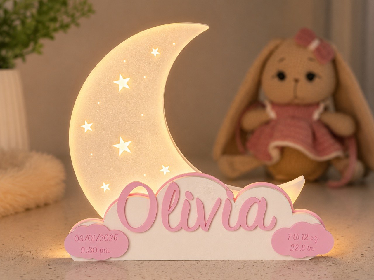 Olivia’s personalized moon lamp glowing beside a soft toy in a nursery